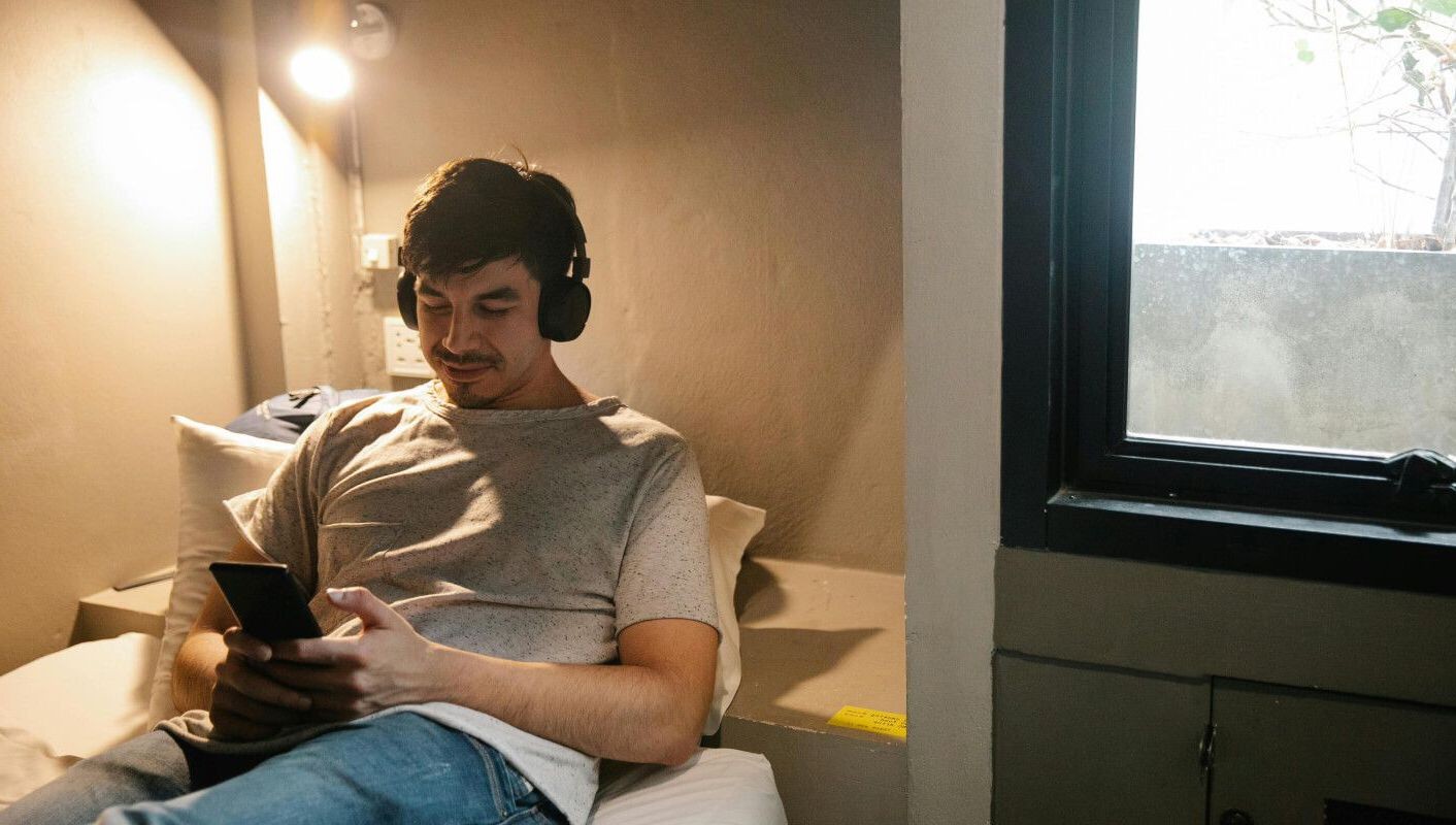 Boy in room looking at phone